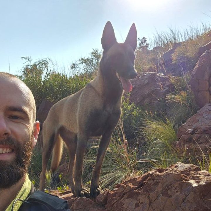 Guy Carosin on a hike with his Belgian Malinois